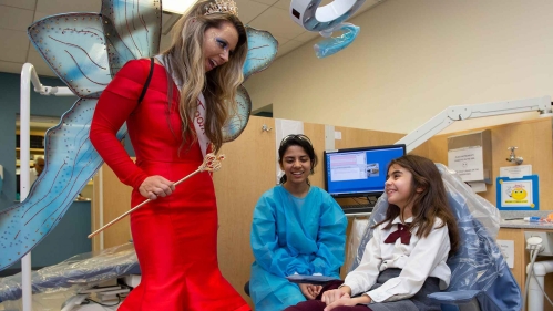 The school of dental medicine's tooth fairy talks to children on Give Kids a Smile Day