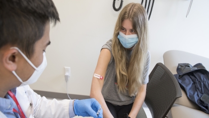 A student gets a Covid vaccine
