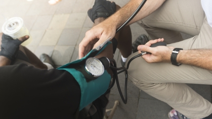 A person's blood pressure is taken at a Newark downtown health screening
