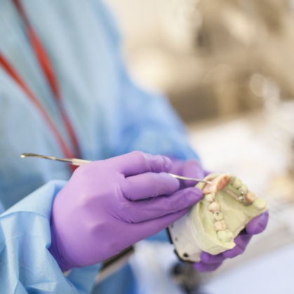 A provider shapes a dental mold