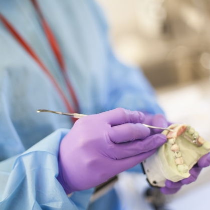 A provider shapes a dental mold