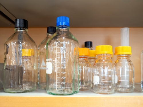 Glass bottles sit on a shelf in a lab at Rutgers