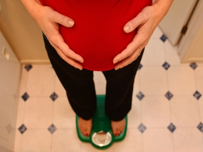 pregnant woman weighs herself