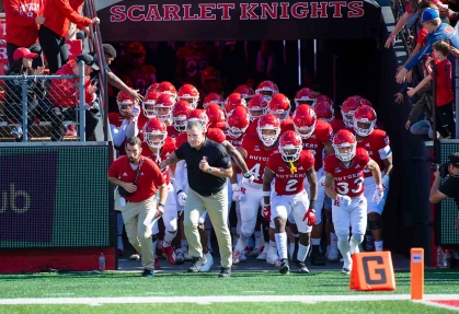 Rutgers football coach Greg Schiano leads the Scarlet Knights onto the field.
